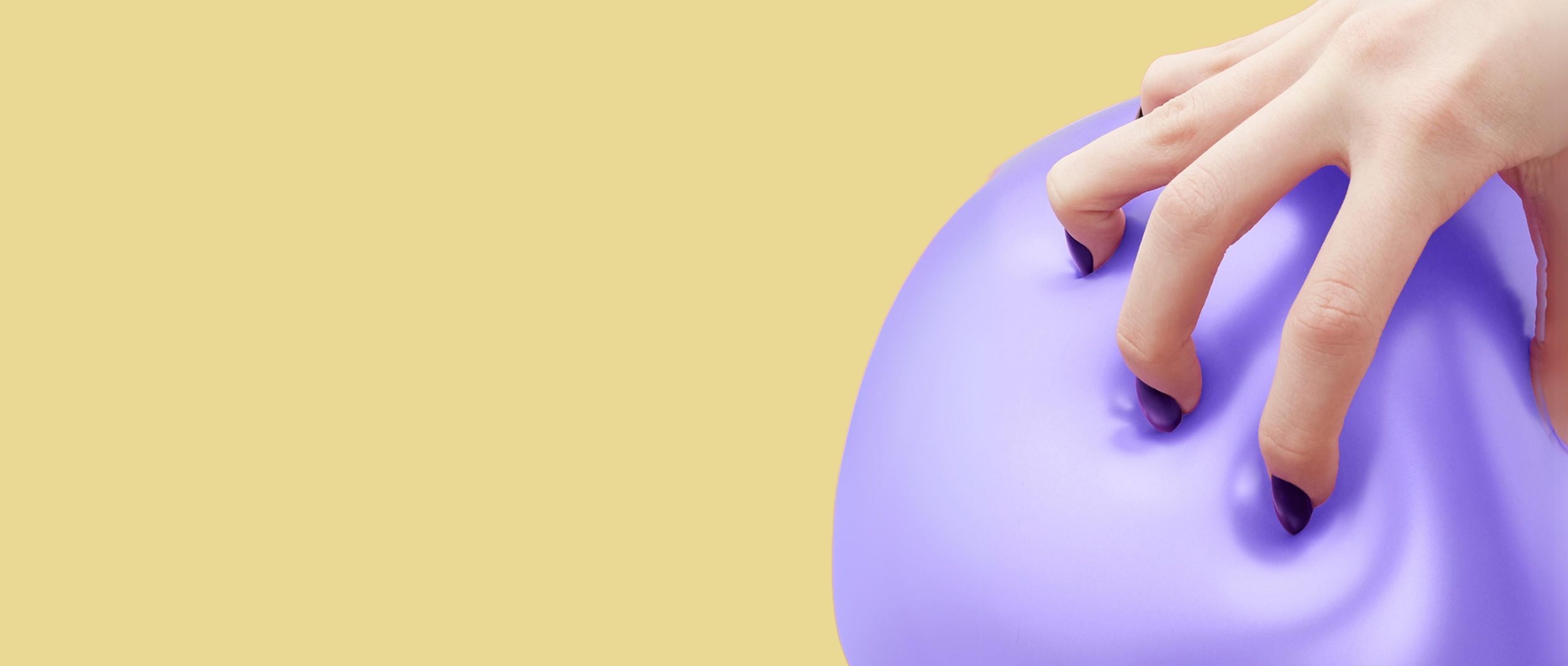 A purple balloon being squeezed by a woman with dark sharp nails demonstrating frictionless checkout.