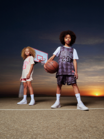two people on basketball court with ball