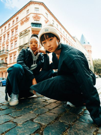 Two girls in an urban setting wearing Puma clothing, accessories and shoes.