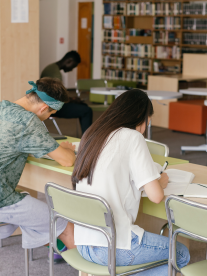 Students sitting at tables, writing an exam