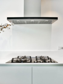 A Dewot gas stovetop in a modern white kitchen