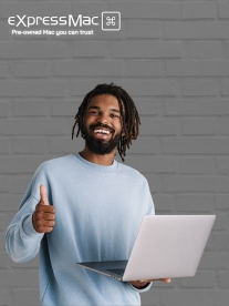 Smiling man holding a macbook