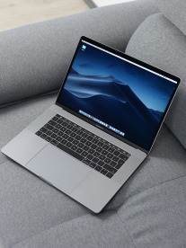 Macbook on a grey couch