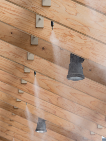 Homemax patio mist system cooling a patio with a wooden roof.