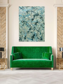 A velvet green couch in a contemporary lounge setting with beautiful abstract art on the wall.