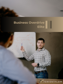 Man presenting ideas on a whiteboard during a business workshop, with “Business Overdrive Elite” branding displayed.