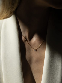 A diamond necklace on a women's chest.