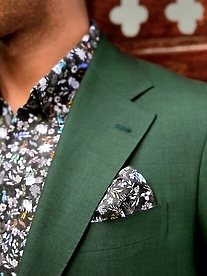green suit with patterned pocket square and shirt