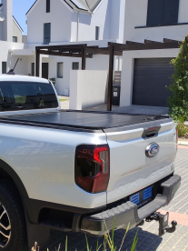 A rented silver VW bakkie truck parked in a street doing a move for superior load