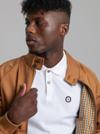 A man wearing a brown oxford jacket and t-shirt from Ben Sherman