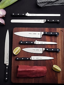 knives in dark kitchen on cutting board