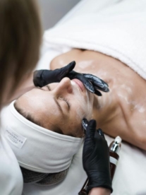 A woman lying in the chair having a medical grade beauty treatment.