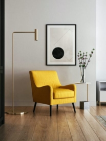 A modern yellow occasional chair in a minimalist lounge.